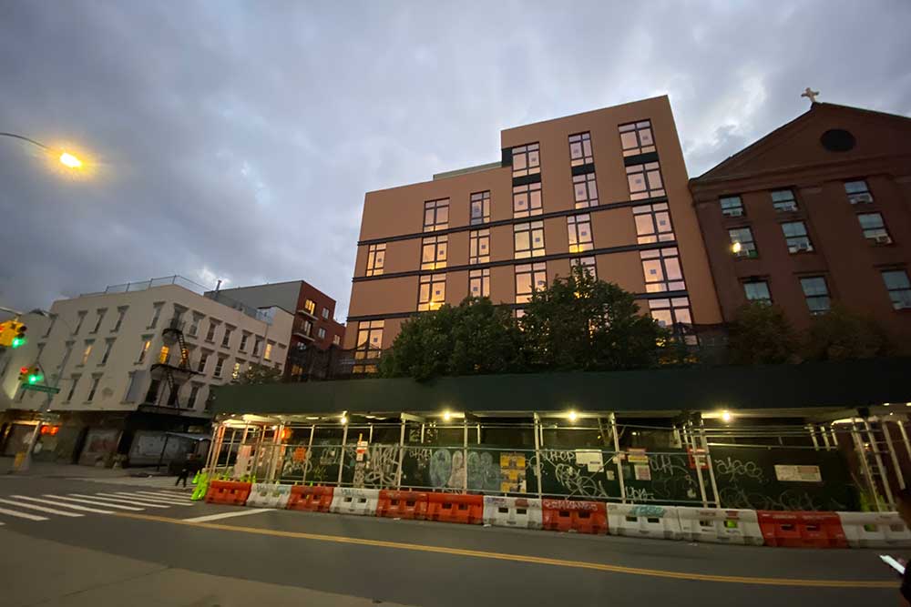 glass goes into the new building at Johnson and Graham Ave