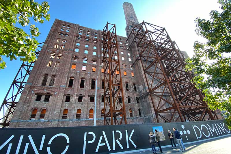 the old domino sugar tower has been reinforced in preparation for conversion and work has begun prepping the site