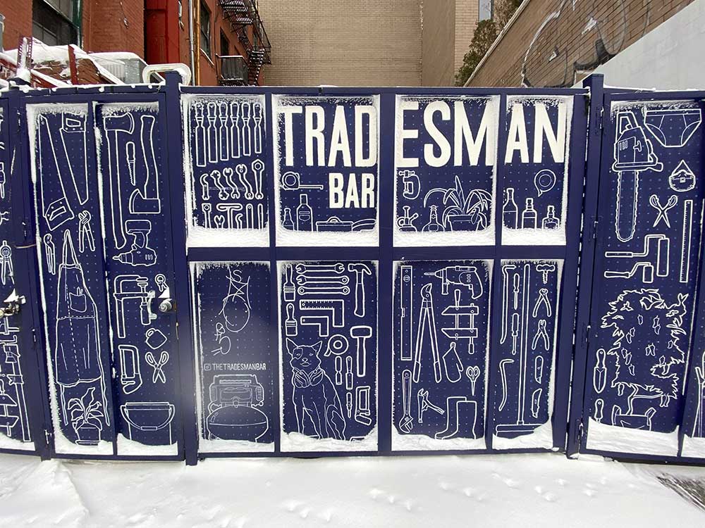 Tradesman bar in the snow of February 2021 showing off their fancy blue doors accessible from the yard