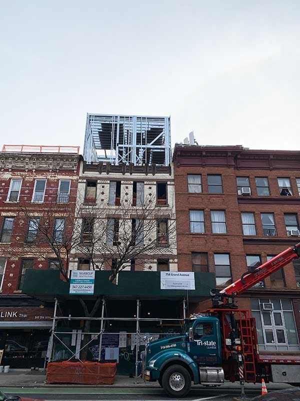 metal frames have been added to 754 Grand Street to extend the height of the building