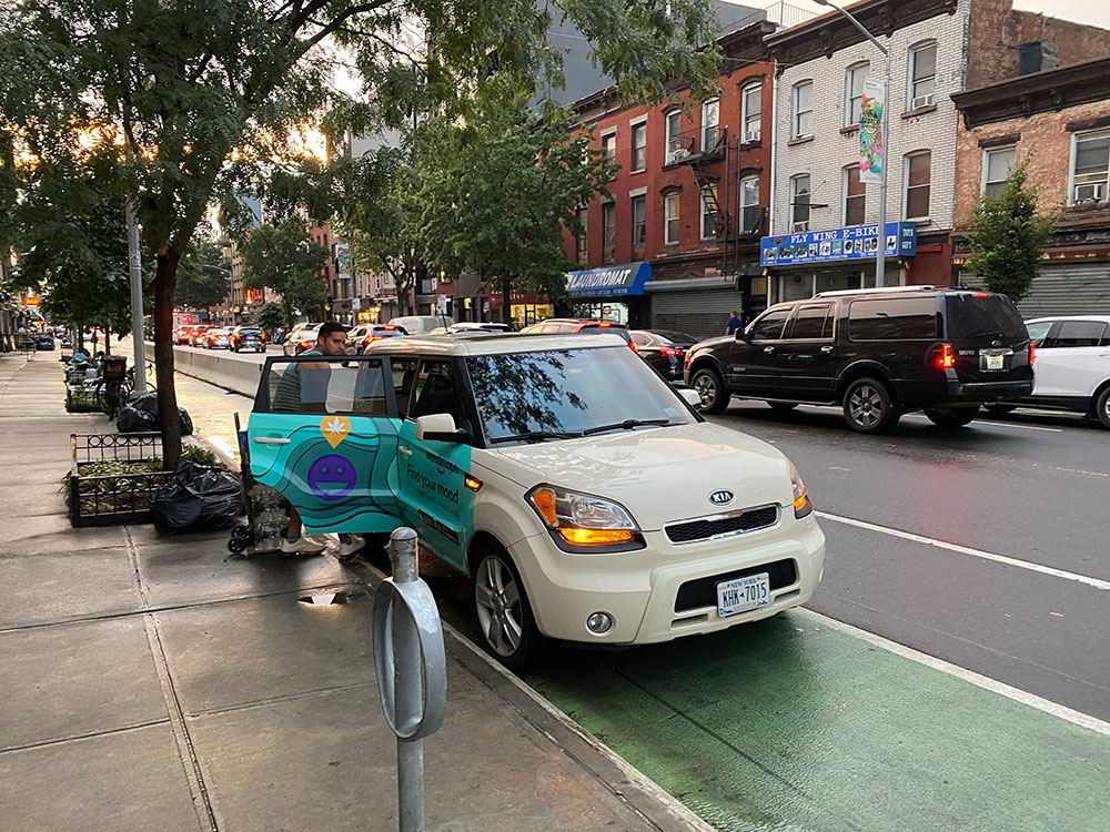 Weedmaps NYC car parking illegally in the unprotected portion of the Grand Street bike lane. Maybe the driver was too high to realize where he parked?