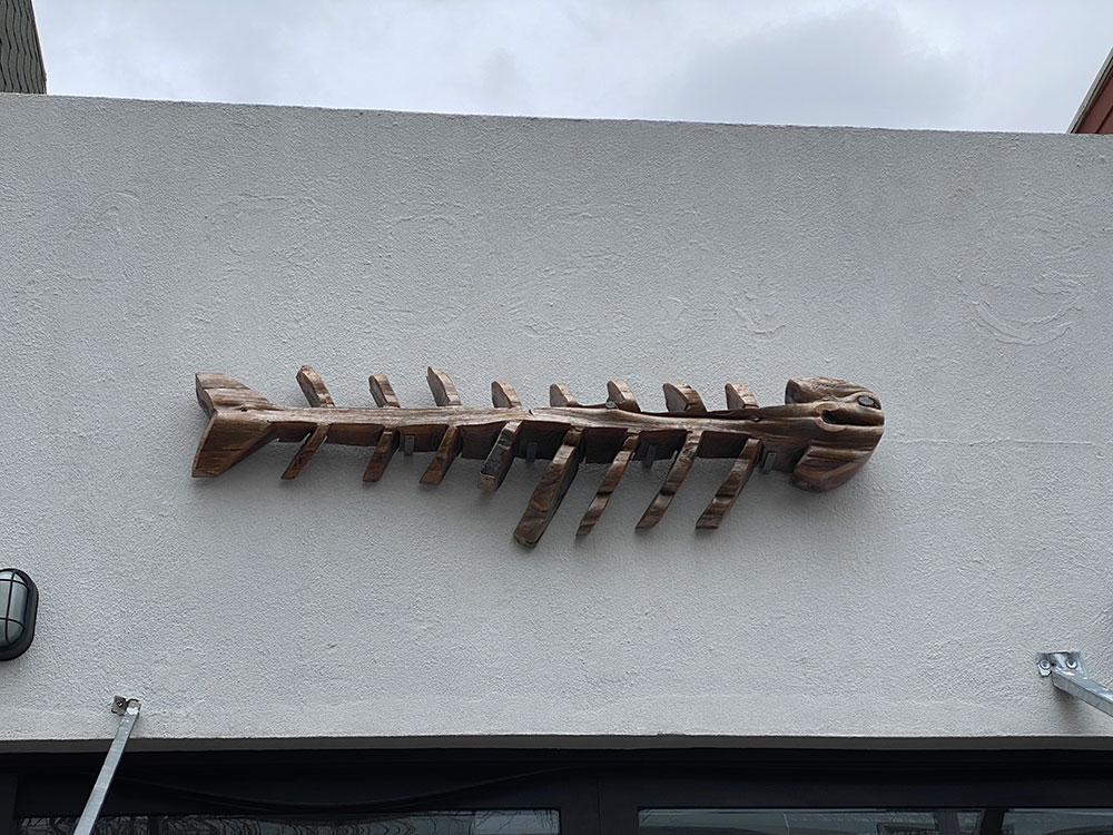 Graham Avenue Brooklyn Cafe Camellia signage made from driftwood looking like a fish skeleton