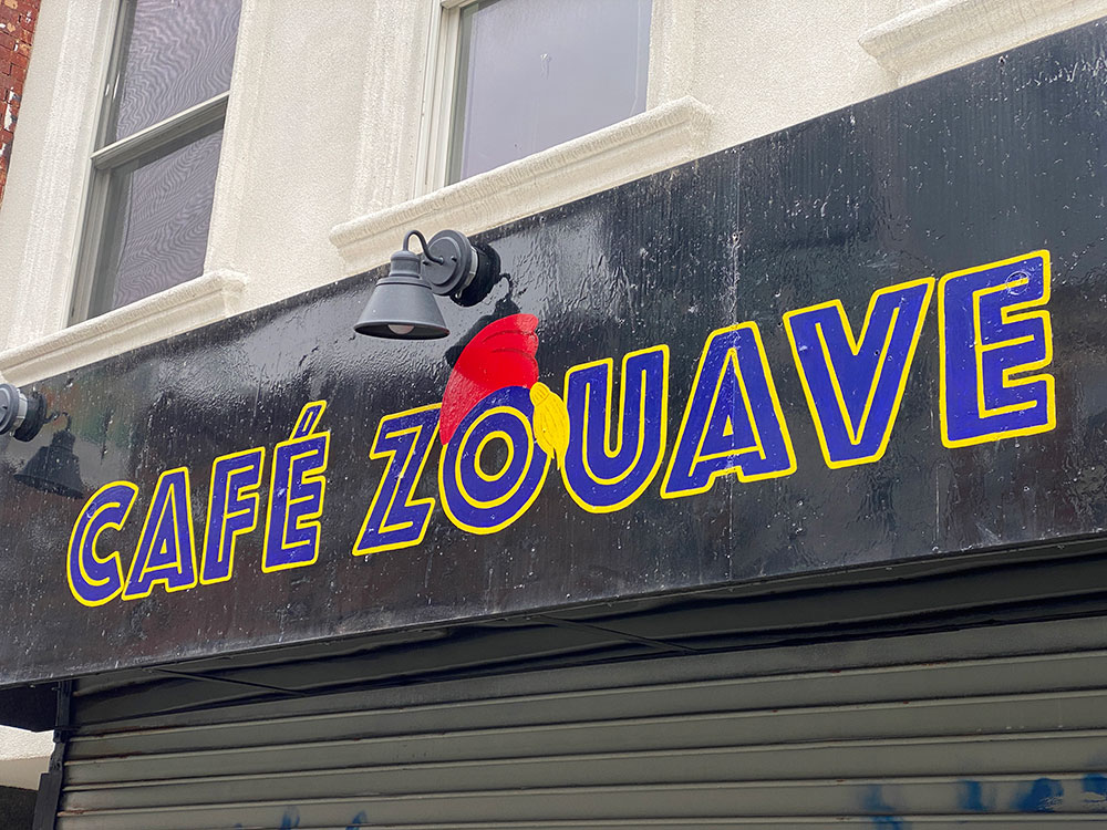 cafe zouave brooklyn on grand street sign